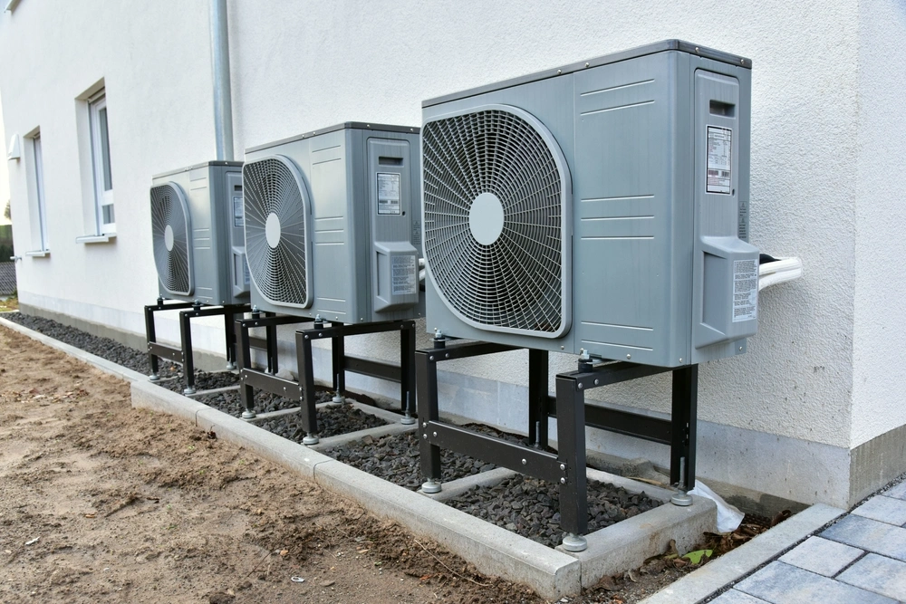 Wall-mounted heat pump condenser units
